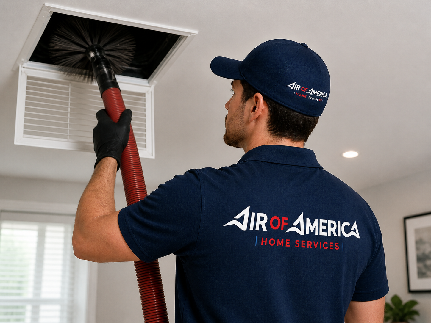 Air of America technician performing professional air duct cleaning in a Virginia Beach home